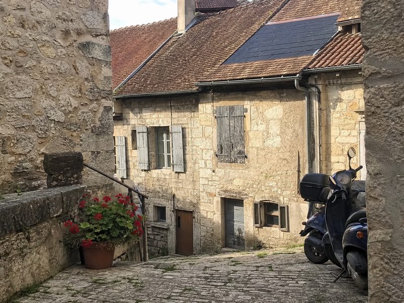 Maison ancienne de Crémieu, tuiles solaires intégrées dans la couverture, au ras des tuiles voisines